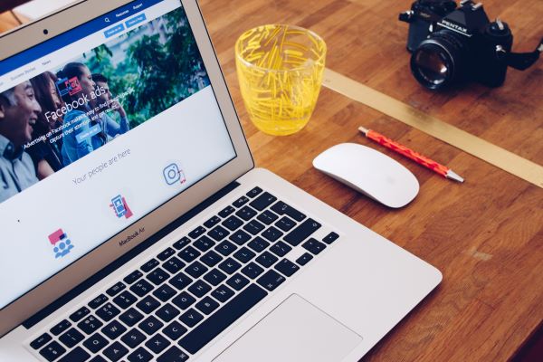 A laptop displaying a Facebook page