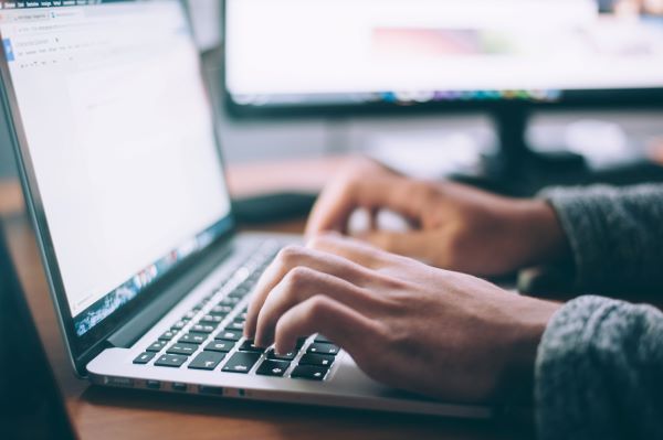 Person typing at a computer