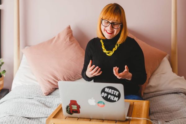 A woman sat in front of a laptop