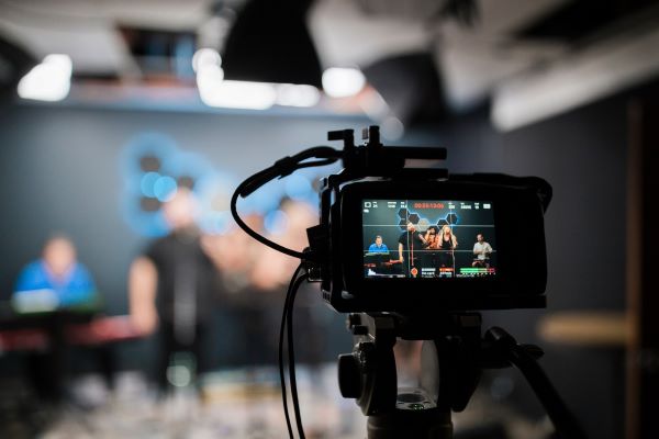 Close up of the viewfinder of a camera filming a group of people