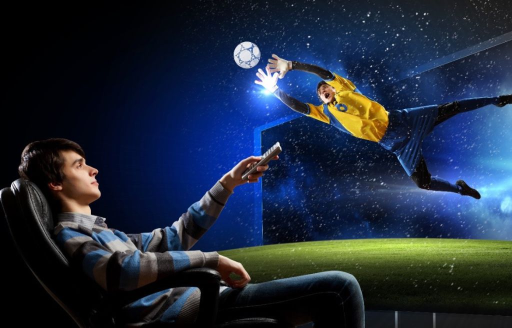 man watching football while sitting on the sofa