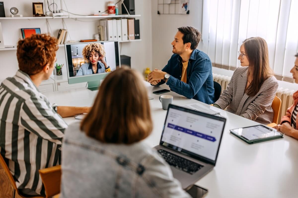 A group of corporates having a hybrid meeting