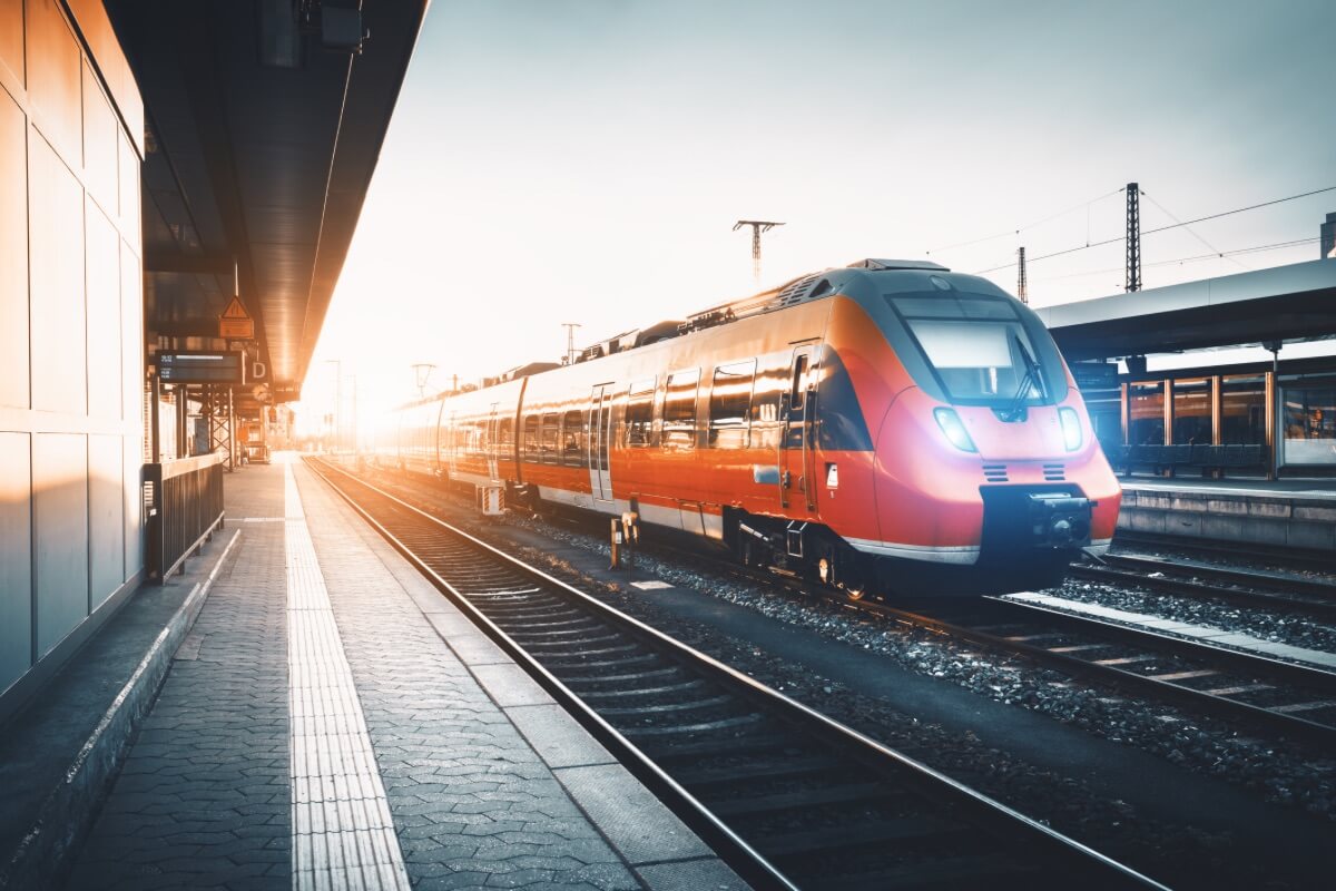 Red train passing through a station