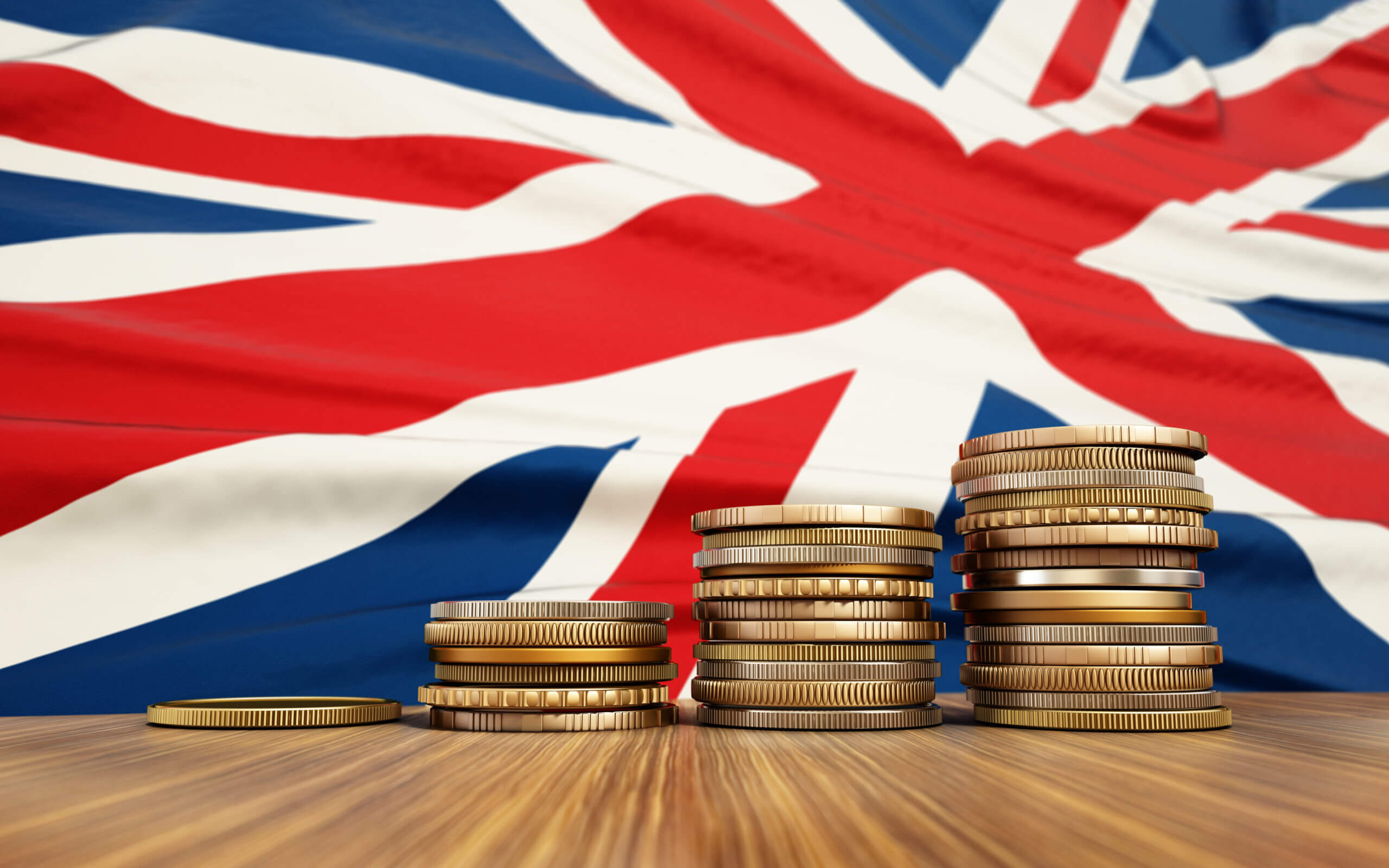 Rising stack of coins with British flag in the background. Economy, finance, interest rates concept