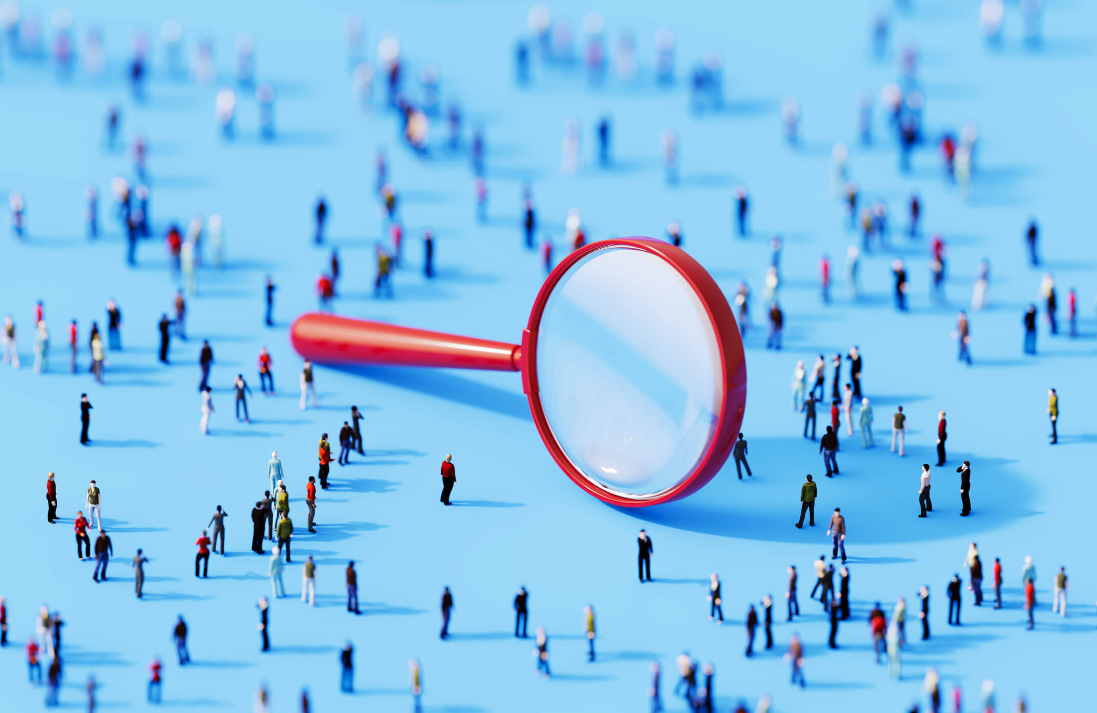 Human crowd surrounding a magnifier object on blue background. Horizontal composition with copy space.