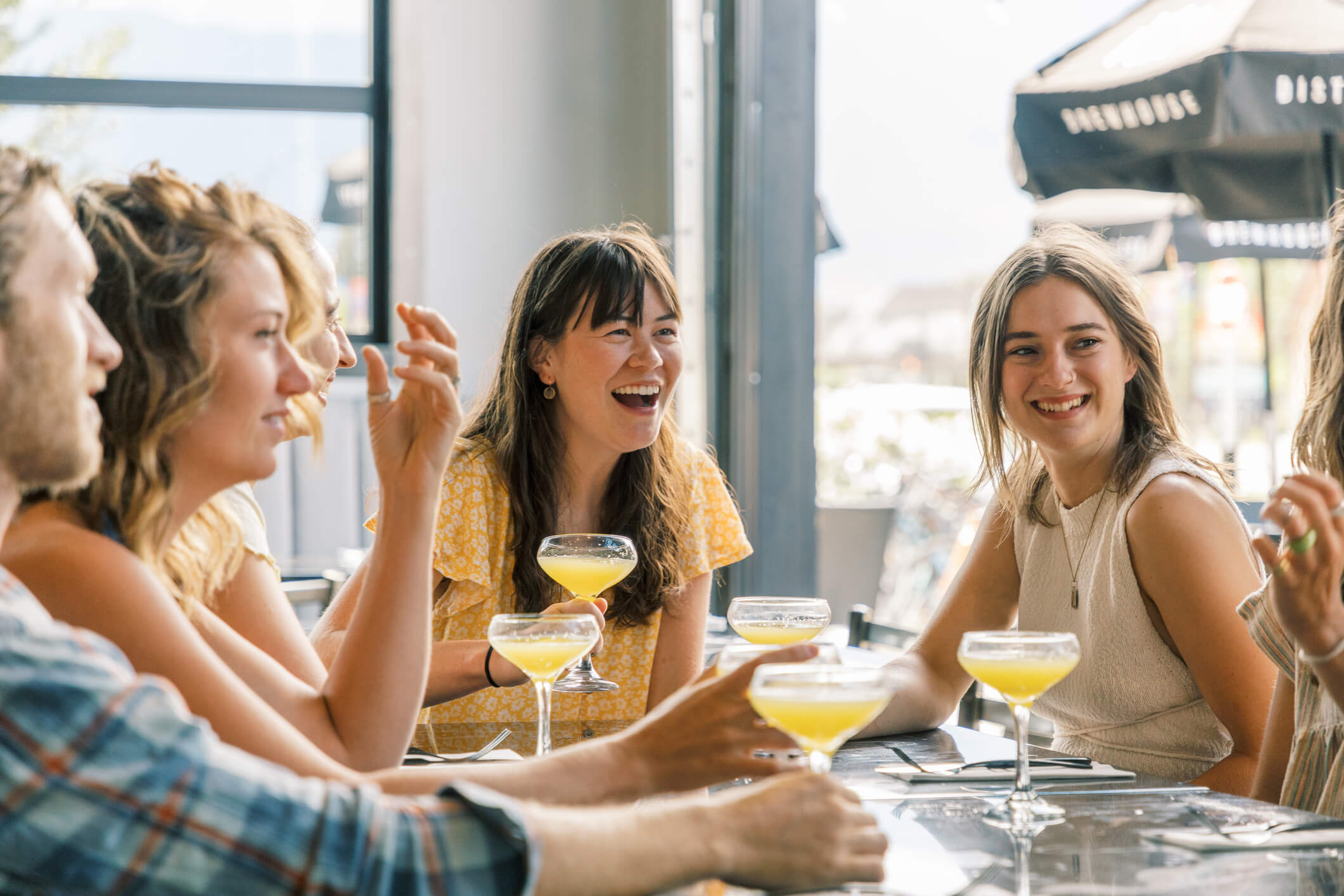Group of friends enjoy drinks at cocktail bar / Brewery