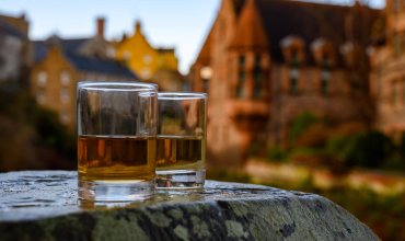 Scotch single malts or blended whisky spirits in glasses with old