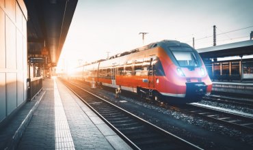Red train passing through a station