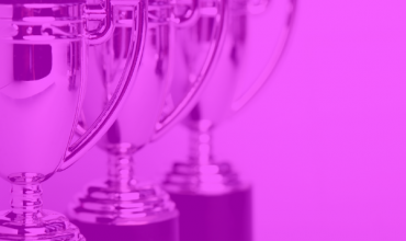 Silver trophies with a pink overlay