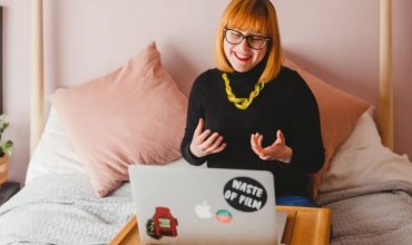 A woman sat in front of a laptop