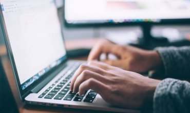 A person typing on a computer